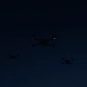 Drones hovering in a somber, empty night sky.